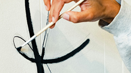 A painter painting on canvas