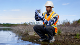 A risk engineer taking a sample of water from the site