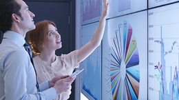 Two colleagues working together on projector screen