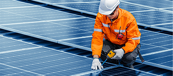 An engineer working with solar panels An engineer working with solar panels