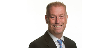 A headshot of Tim Smith