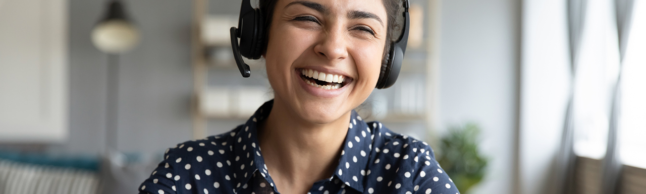 A woman on a work call and laughing