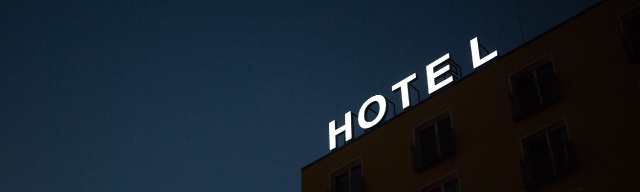 Hotel Sign lit up on top of a hotel building