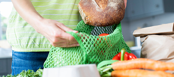 Vegetables on the table and some being packed in the bag