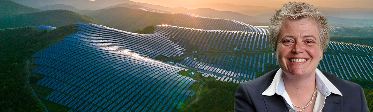 A headshot of Vicky Robert Mills with solar panels