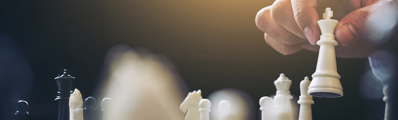 A hand holding a chess piece