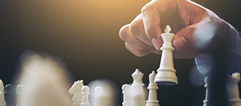 A hand holding a chess piece