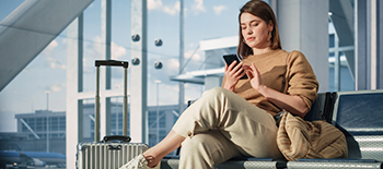 A woman sitting and using her phone