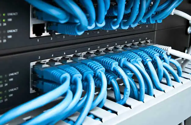 Wires and cables attached to computer for cyber security budget