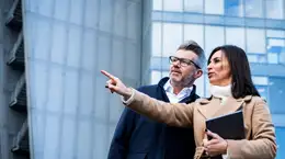 Two people pointing at something in infinity