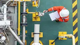 An engineer taking readings from a machine meter for PRC Tools